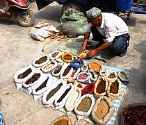 Spice seller at a market in Kashgar, China