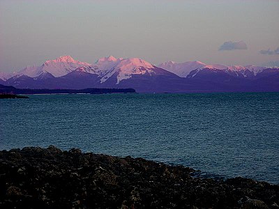 Sunset at Auke Bay, Alaska. Thanks to Rayleigh scattering, the mountains appear purple.