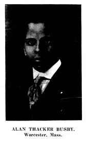 Photograph of a young Black man wearing a suit and tie