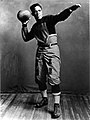 Fritz Pollard, posing with a football