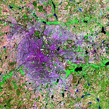 A false colour composite satellite image of Greater Bangalore. It is from 2006 therefore some green areas between lakes are visible. Built up area is in purple.