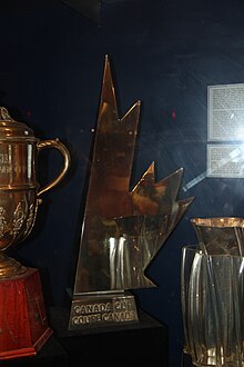 silver trophy shaped like half of a maple leaf