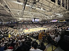 A wide angle photograph of the Siegel Center with a sold out crowd during a "White Out" game against the Richmond Spiders.