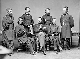 A black and white photograph of seven men