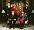 Image 92Formal family portrait of former Indonesian's President B.J. Habibie. Women wear kain batik and kebaya with selendang (sash), while men wear jas and dasi (western suit with tie) with peci cap. (from Culture of Indonesia)