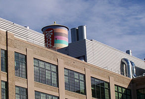 Necco Factory, 2004, featuring water tower that had been painted (in 1996) to resemble a roll of Necco Wafers candy. Picture taken shortly before tower was repainted to Novartis design