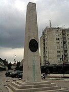 Obelisk near a tall building