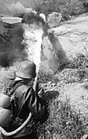 A German soldier operating a flamethrower in 1944