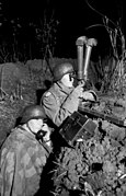 A team of German artillery observers using periscope binoculars, 1943