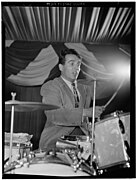 Gene Krupa with two cymbals mounted on a bass drum