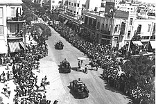 British armoured vehicles parading through Allenby Street in Tel Aviv, in honor of the Silver Jubilee of King George V in 1935
