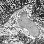 What is thought to be a frozen pond on Pluto, about 20 miles (30 kilometers) across