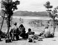 A .50 Cal. Machine gun squad of Co. E, 2nd Battalion, 7th Regiment, 1st Cavalry Division, fires on North Koreans along the north bank of the Naktong River, 26 August 1950.