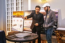 Nayib Bukele and Fernando Romero viewing and standing over a model of the Bitcoin City airport terminal design