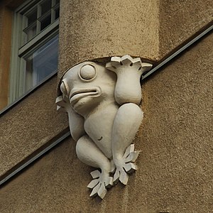 A frog statue supporting an engaged column on the Agronomy House in Helsinki, Finland