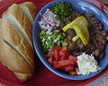ful Beans with variety of vegetables, feta cheese and bread, flavored with Berbere spice and olive oil.