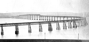Black and white photograph of the Tay Bridge before its collapse. The photograph is taken from the North.