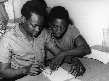 Association for the training of workers from Africa and Malagasy. Literacy training in the 'Quaker Friends' hostel. Two of the workers during an arithmetic lesson. Paris, France.