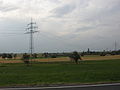 A 110 kV-line with two communication cables fixed like garlands on grounded ropes on a half of the lowest crossbar