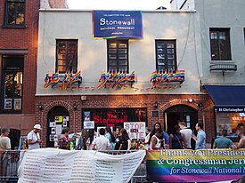 Facade of the Stonewall Inn, adorned in numerous rainbow flags for the announcement of the site being designated a National Monument.