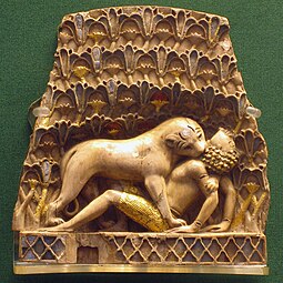 Nimrud ivory plaque, with original gold leaf and paint, depicting a lion killing a human (British Museum)