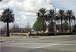 Typical entrance to parking lot, featuring lush landscaping