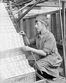A female worker changing jacquard cards in a lace machine in a Nottingham factory (1918 (First World War)).