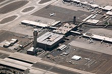 aerial view of Sky Harbor airport, showing the spoke structure of the terminals and gates, with the spike of the control tower toward the lower left of the picture.