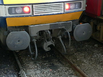 "Drophead" coupler swung down reveals buffers and chain coupler on a British Rail Class 91.