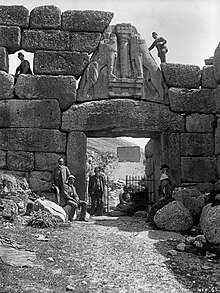 Black and white photograph of the Lion Gate at Mycenae.