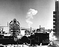 Image 27This view of downtown Las Vegas shows a mushroom cloud in the background. Scenes such as this were typical during the 1950s. From 1951 to 1962 the government conducted 100 atmospheric tests at the nearby Nevada Test Site. (from Nuclear weapon)