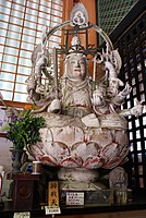 Statue of Benzaiten, a torii and a male Ugajin visible on her head (whose coiled serpent body is barely visible behind her crown)