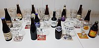 Thirteen trappist beers and their glasses.