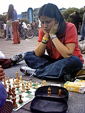 A girl playing chess in Mexico City.