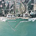 Aerial view of the Fukushima I plant area in 1975, showing sea walls and completed reactors
