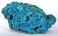 Powder-blue chrysocolla as stalactitic growths and as a thin carpet in vugs inside a boulder of nearly solid tyrolite, from the San Simon Mine, Iquique Province, Chile (size: 14.1 cm × 8.0 cm × 7.8 cm (5.6 in × 3.1 in × 3.1 in))