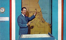 Harry Volkman giving a weather broadcast