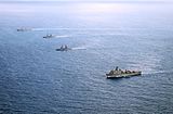 From top left, the guided missile destroyer USS John S. McCain (DDG-56); the Philippine frigates BRP Gregorio del Pilar (FF-15) and BRP Ramon Alcaraz (FF-16); and the amphibious dock landing ship USS Ashland (LSD-48) while in formation during CARAT Philippines 2014.