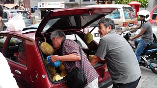 Street vendors selling durians out of a car in Johor Bahru, Malaysia