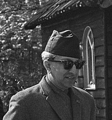 A smiling King Mahendra, wearing sunglasses