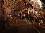Inside a cave, dripstone formations and a path for visitors