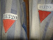 Red emblems on a Dachau detainee's clothing marking them as a political prisoner