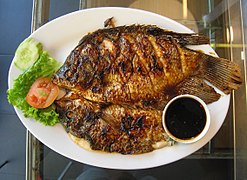 Gurame bakar (grilled gourami) served with sweet soy sauce as both marination and dipping sauce
