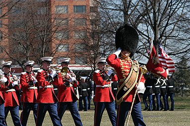 Master Gunnery Sgt Thomas D. Kohl leads the Marine Band during the 60th anniversary of the Battle of Iwo Jima commemoration ceremony at the Marine Corps War Memorial, 2005