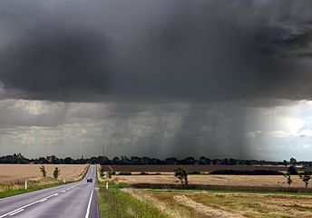 Late-summer rainstorm in Denmark. Nearly black color of base indicates main cloud in foreground probably cumulonimbus.