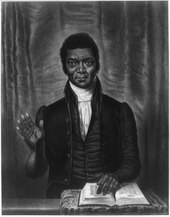 Portrait peint d'un homme noir assis derrière une table, main droite levée, main gauche posée sur un livre