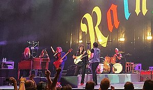 Rainbow performing in 2017. (From left to right) keyboardist Jens Johansson, backing vocalists Lady Lynn and Candice Night, bassist Bob Nouveau, guitarist and founder Ritchie Blackmore, singer Ronnie Romero and drummer David Keith