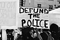 "Defund the police" sign held by a demonstrator at a George Floyd protest on June 5, 2020