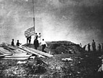 First Marine Battalion (United States) hoisting the flag at the Battle of Guantánamo Bay during the Spanish–American War, in 1898