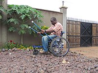 A Leveraged Freedom Chair wheelchair user in Kenya. The chair has been engineered to be low-cost and usable on the rough roads common in developing countries.